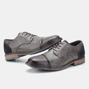 Detailed view of men's rubbed leather business shoes with blue sole accent