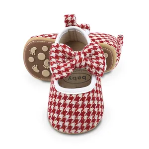 Detailed view of red houndstooth baby walking shoes with bow and anti-slip sole