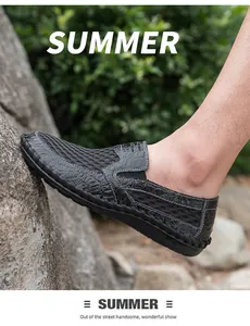 Side view of men's breathable black mesh slip-on shoes in a natural outdoor rock setting