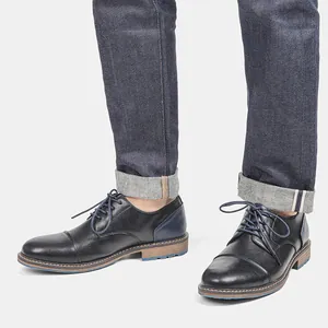 Detailed side view of men's black textured leather business casual oxfords with blue accents