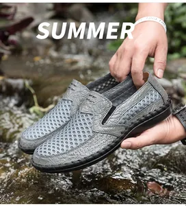 Detailed close-up of grey breathable mesh slip-on men's loafers held over a summer stream