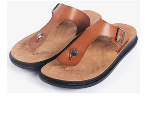 Detailed view of stylish brown leather thong sandals featuring decorative metal buckles