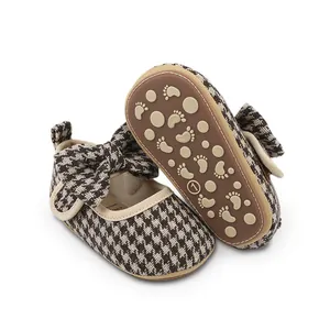 Detailed view of baby girl houndstooth pre-walker shoes with anti-slip rubber sole.