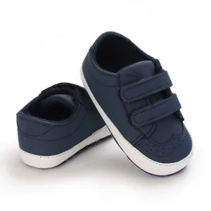 Close-up of navy blue baby walking shoes with soft soles and velcro straps