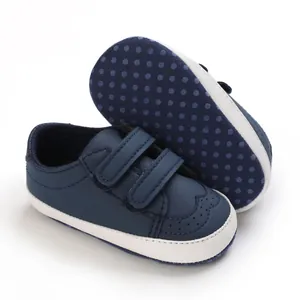 Detail view of navy blue baby pre-walker shoes with white soft sole and velcro straps