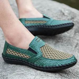 Casual men's green breathable mesh slip-on loafers shown in an outdoor rock setting