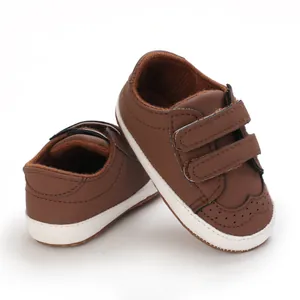 Detail view of brown soft sole baby walking shoes with double hook and loop straps.