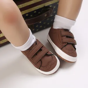 Classic brown baby walking shoes with brogue perforations and comfortable soft soles