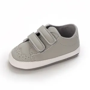 Close-up of a grey baby pre-walker shoe featuring double velcro straps and soft sole