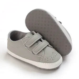 Soft-sole grey baby walking shoes with double hook-and-loop straps and anti-slip sole