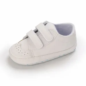 Detailed view of white faux leather baby walker shoes with double velcro straps
