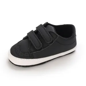 Detailed view of black baby walking shoes with soft soles and velcro straps