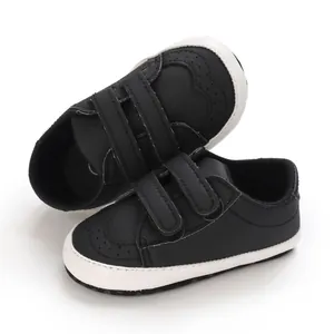 Detail view of black soft sole baby walking shoes with durable dual Velcro straps