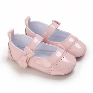 Detailed view of pink patent leather baby princess walking shoes with cute bow strap