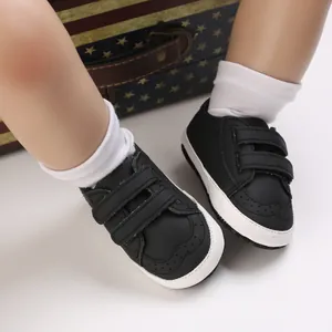 Close-up of black baby walker shoes featuring soft soles and double velcro straps design