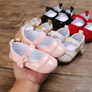 Close-up of pink baby princess walker shoes with delicate bow detail and soft sole