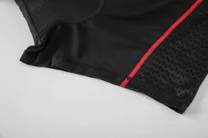 Close-up of breathable mesh fabric and red flatlock seams on black cycling shorts
