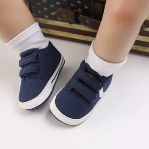 Vista detallada de zapatillas de lona azul marino para bebé con suelas blandas.