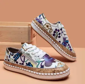 Macro detail of women's ethnic floral print platform loafers with a stylish side zipper