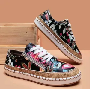 Detailed view of women's ethnic floral print platform sneakers with side zipper design