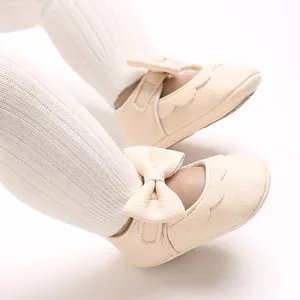 Detailed view of beige baby girl pre-walker princess shoes with elegant bow and soft sole.