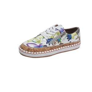 Detailed view of women's floral print loafers with side zipper and thick cork-textured sole