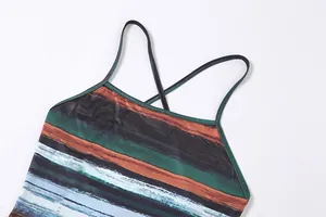Detailed view of the cross-back spaghetti straps and vibrant multi-colored striped print