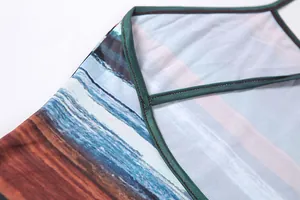 Close-up view of beach print detail and fine straps on a summer backless dress