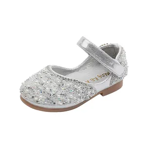 Detail shot of silver girls Mary Jane shoes with sparkling rhinestones and pearls