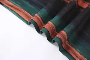 Close-up detail of high-quality stitching and green rust striped printed fabric texture