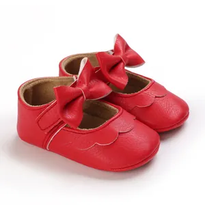 Nahaufnahme der roten Baby-Prinzessin-Lauflernschuhe mit Schleife und Wellenrand