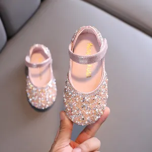 Elegant pink glittery girls' Mary Jane shoes with faux pearls and rhinestones decoration.