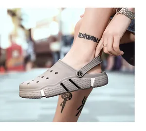 Close-up view of breathable gray clog sandals for men on feet in an outdoor setting