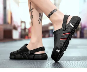 Casual black men's outdoor clogs with red accents shown in a street walking scene.