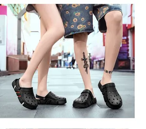 Couple wearing black casual garden clogs on a modern city street background outdoor