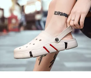 Close-up of cream casual garden clogs with breathable holes and heel strap