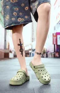 Close-up of men's casual green clogs with breathable holes for beach or outdoor wear