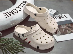 Close-up detail of beige summer hole clogs showing the breathable textured surface