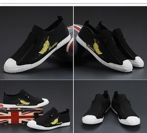 Detail view of men's breathable black mesh sneakers with yellow feather embroidery