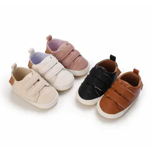 Group view of soft-soled baby walking shoes in five neutral colors with Velcro straps.