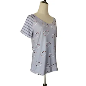 Side view detail of a gray plus size T-shirt with heart print and striped sleeves