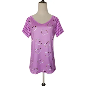 Macro view of purple women's short-sleeve T-shirt featuring a heart print design.