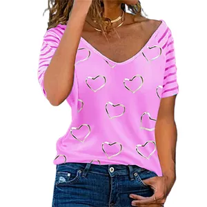 Close-up of pink V-neck T-shirt featuring silver heart prints and striped sleeves