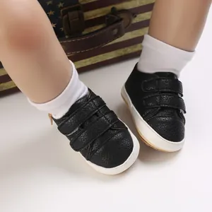 Detailed view of black baby soft sole walking shoes featuring comfortable velcro straps