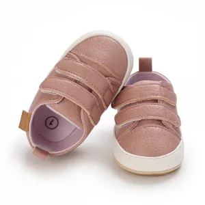 Pinkish-brown baby walking shoes with triple velcro straps and soft white rubber soles.