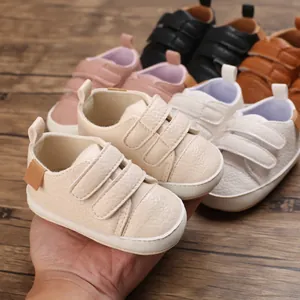 Detailed macro view of soft faux leather baby pre-walker shoes with dual strap closure