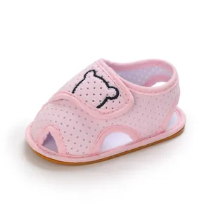Close-up of pink baby mesh walking sandals with cute bear embroidery and soft rubber sole