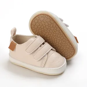 Close-up of beige baby walker shoes featuring soft non-slip soles and double Velcro straps