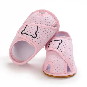 Detail view of pink baby mesh sandals with cute bear embroidery and soft rubber sole
