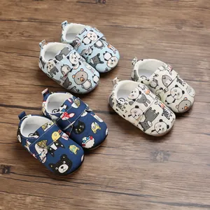 Detailed macro view of soft-sole cartoon walking shoes for infants with velcro straps